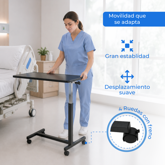 Mesa puente Handy MP junto a una cama, con la base de cuatro ruedas y el freno.