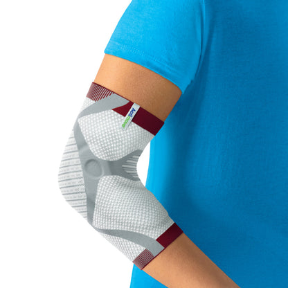 Actimove EpiMotion colocada en el codo, etiqueta Actimove visible